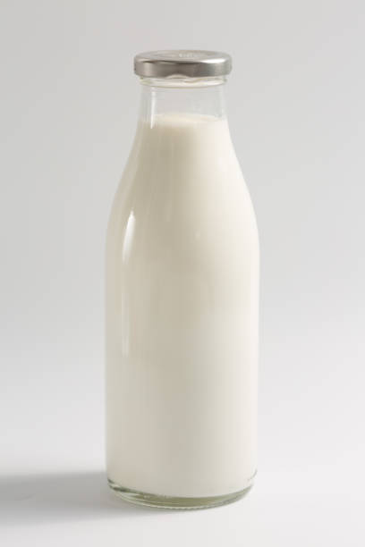 istock Glass bottle with milk on a white background 1382390449