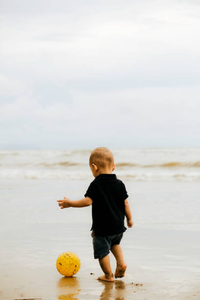 istock baby playing football on the beach 1382397228