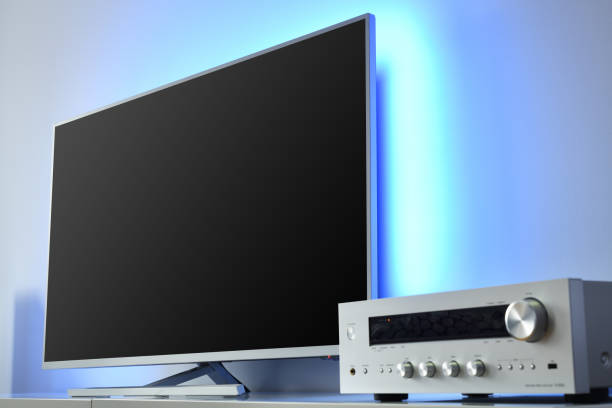 Large LED TV with backlight and audio receiver in a modern apartment.