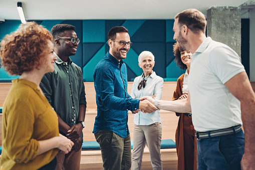 Smiling business persons shaking hands