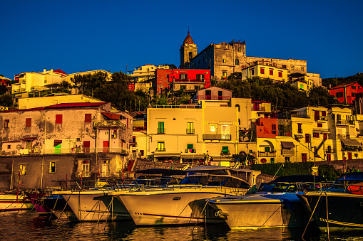 The fishing village of Massa Labrense Italy on the Sorrento peninsula with fishing boats lining the harbor.