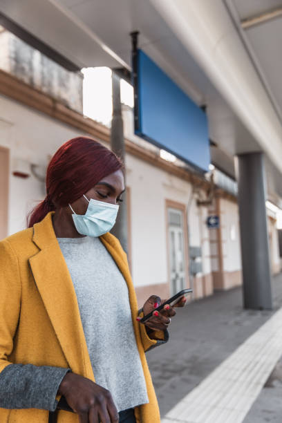 istock Woman at the train station waiting on platform 1382409719