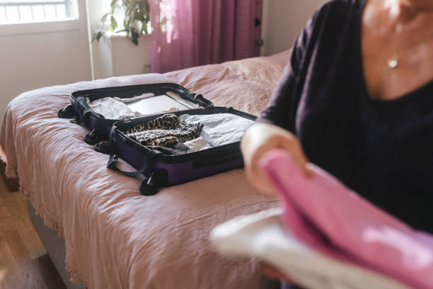 istock Packing clothes into a bag for vacation 1382428907