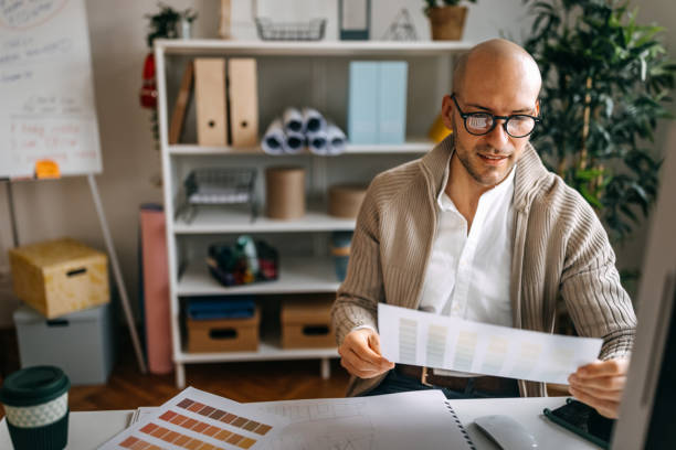 Businessman analyzing color swatch at desk in office