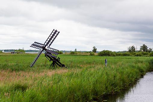 Small wooden water mill along walk way behind visitor center Nationaal Park Weeribben-Wieden in Overijssel in The Netherlands