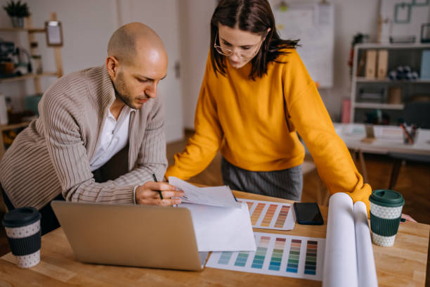 istock Interior designers analyzing color swatches on desk in office 1382438120