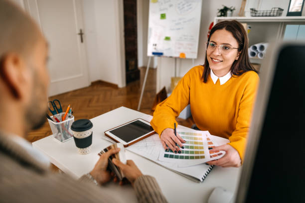 istock Colleagues brainstorming at desk in small office 1382445712