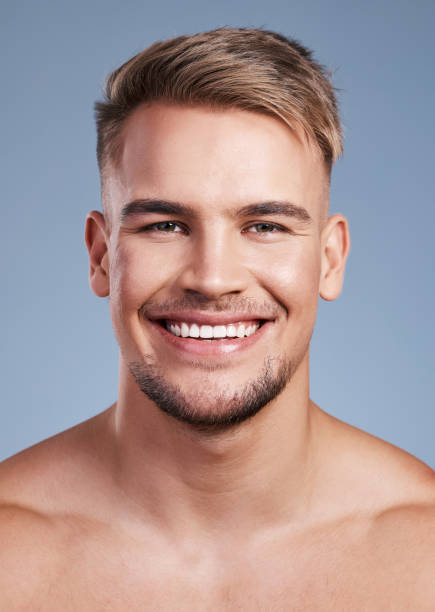 istock Closeup shot of a handsome young man smiling while posing against a studio background 1382447000