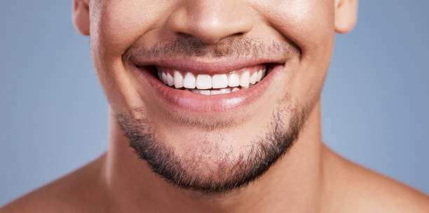istock Closeup shot of a young man smiling while posing against a studio background 1382447003