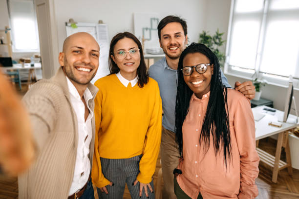 istock Business people taking selfie with mobile phone in office 1382447110