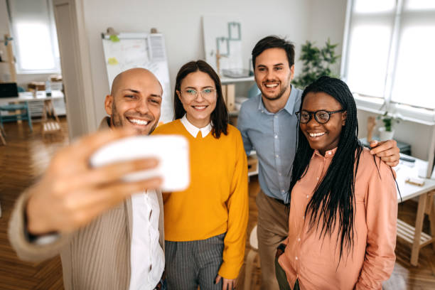 istock Business people taking selfie with mobile phone in office 1382447134