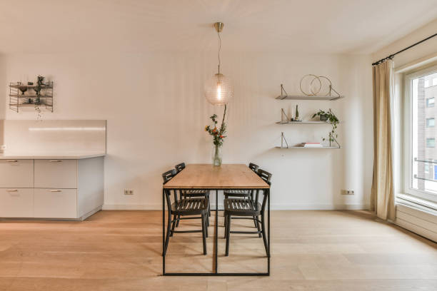 istock Table and chairs under lamps in dining room 1382449397