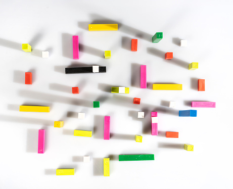 top view of colored cubes and bars on a white surface