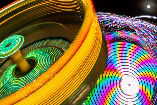 Tilta-Whirl in foreground and a boat swing in the background.  Abstract and colorful