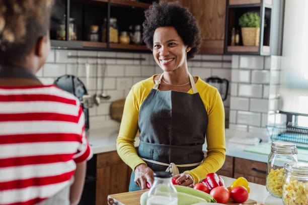 istock Daughter spends time with her mother and helps her in the kitchen 1382455611