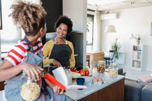 istock Daughter spends time with her mother and helps her in the kitchen 1382457251