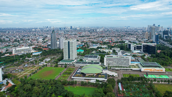 Aerial view of the Indonesia Parliament Complex, which is also known as the DPR or MPR building with Jakarta cityscape. Jakarta, Indonesia