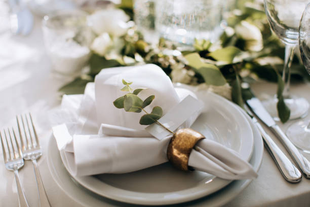 istock Elegant Place Setting with gold and white decoration in restaurant. Table set 1382459346