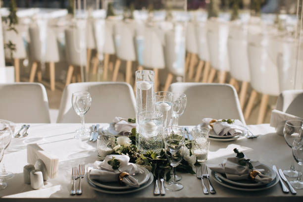istock Decorated wedding table with candles and white flowers 1382459351