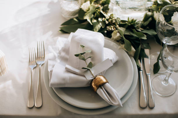 istock Elegant white dining table setting in the restaurant for the wedding dinner 1382459401