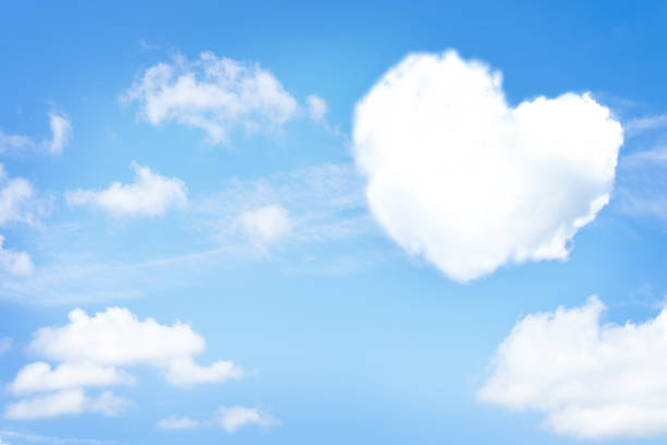 istock Cloud in a heart shape on bright sky background. Copy space 1382459734