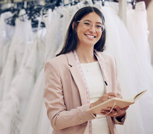 istock Shot of an attractive young seamstress writing notes while working in her boutique 1382460358
