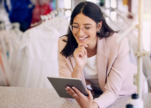 istock Shot of a seamstress using a digital tablet while working in a boutique 1382460391