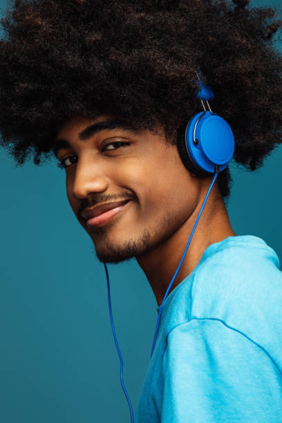 istock African american man with african hairstyle using phone 1382468073