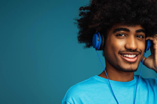 istock African american man with african hairstyle using phone 1382468092