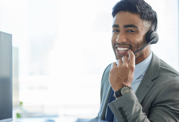 istock Shot of a young man wearing a headset while working in a call center 1382470976