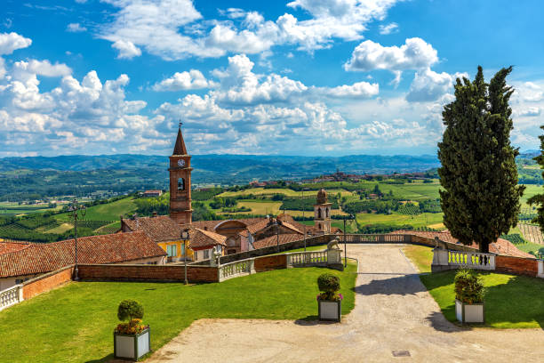 town of govone overlooking green hills under beautiful sky in italy. - religion christianity bell tower catholicism imagens e fotografias de stock