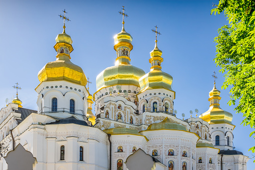Belogorsky Monastery (Perm region, Russia) in summer. A majestic white-stone temple with golden domes on a high mountain against the backdrop of thick clouds. Popular tourist and pilgrimage route