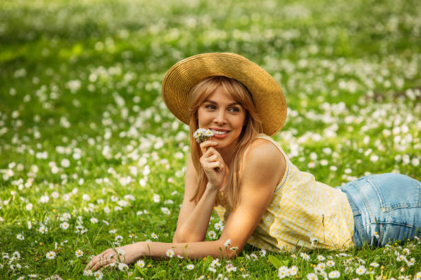 Beautiful woman among daisies