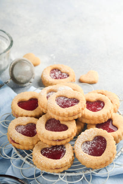 istock Traditional Linzer cookie with strawberry jam and powder sugar on light grey beautiful background. Top view. Traditional homemade Austrian sweet dessert food on Valentines Day. Holiday snack concept. 1382477455