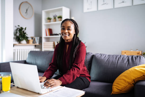 istock Smiling African woman working at home and looking at camera 1382479319