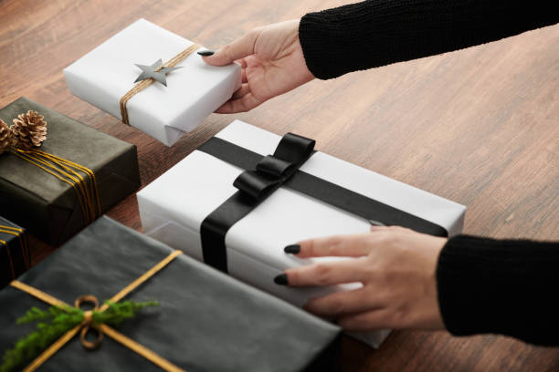 istock Woman Putting Wrapped Presents on Table 1382479427