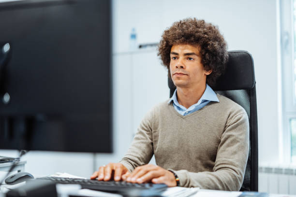 istock African American businessman in office using desktop PC 1382479537