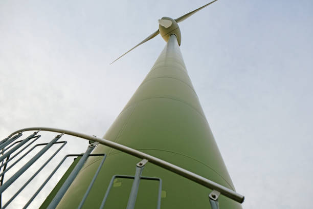 istock Wind turbines on blue sky background.Alternative energy sources. wind generator Bottom view. Wind energy symbol. Natural Wind energy symbol. 1382479774