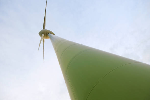 istock Wind turbines on blue sky background.Alternative energy sources. wind generator Bottom view. Wind energy symbol. 1382479776