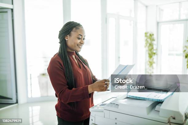 Africanamerican Businesswoman Working In Office After Reopening Using Photo Copier Stock Photo - Download Image Now