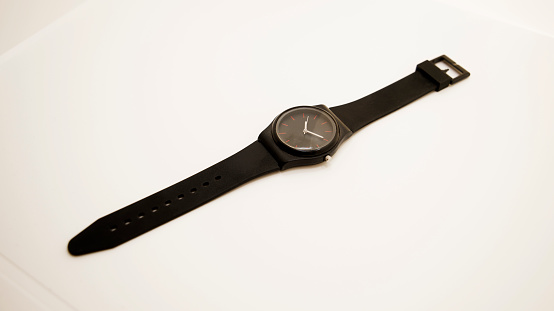 stretched wrist watch on white background