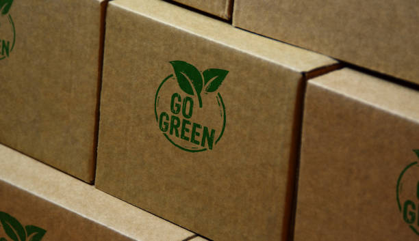 Go green and eco friendly symbol stamp and stamping Go green and eco friendly symbol stamp printed on cardboard box. Co2 neutral, ecology, environment, nature and climate concept. packaging stock pictures, royalty-free photos & images