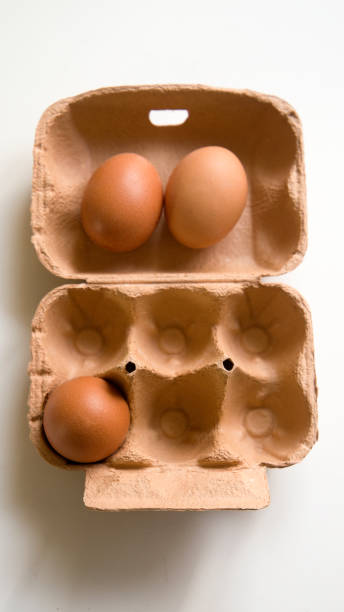 open egg cup with one egg and 2 eggs out - three different refrigerators imagens e fotografias de stock