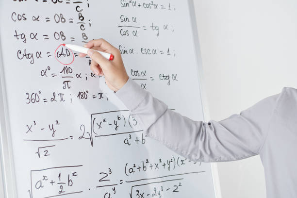Math Teacher Circling Variable in Formula Hands of math teacher circling variable in formula on whiteboard with red highlighter when explaining topic to students divergent movie review stock pictures, royalty-free photos & images