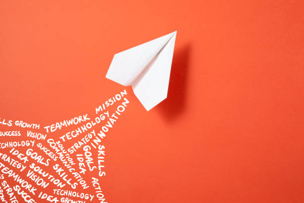 istock Paper Plane on Orange Colored Background 1382488744