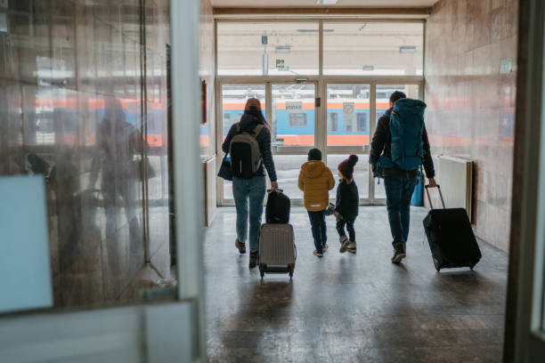 Family with two children at the train station Family with two children at the train station emigration and immigration stock pictures, royalty-free photos & images