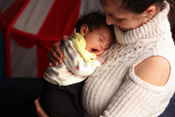 Mother cuddling with her baby daughter