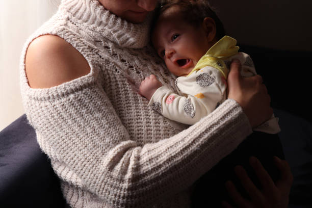 istock Mother cuddling with her baby daughter 1382491183