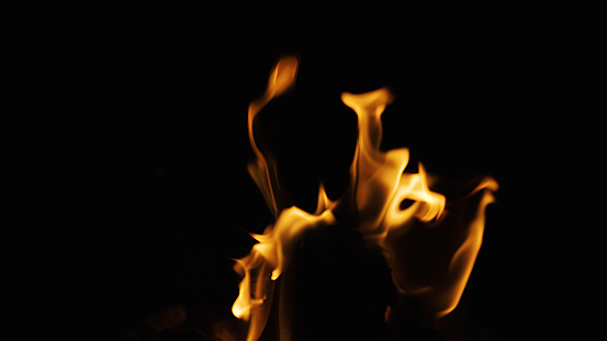 Burning torch on a black background. Ideal for compositing with another image. The background can be removed with a blending mode like screen.