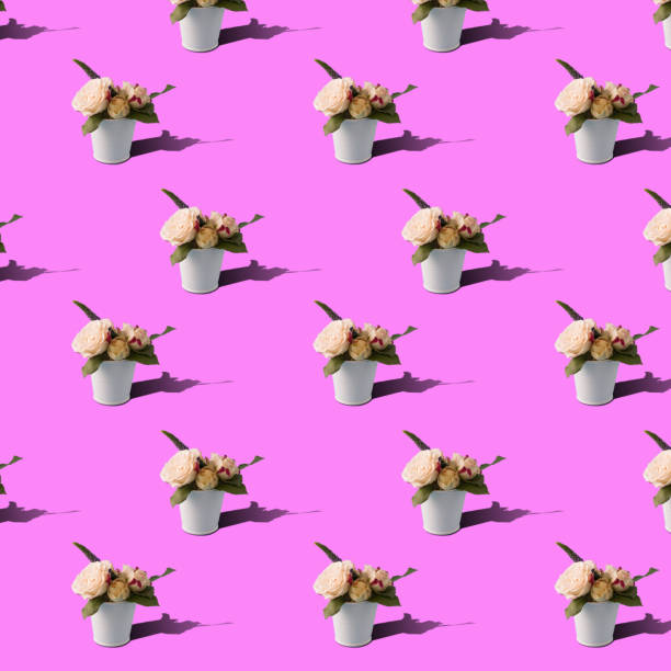 istock a pattern of bush roses in a white small bucket on a pink background. 1382505313